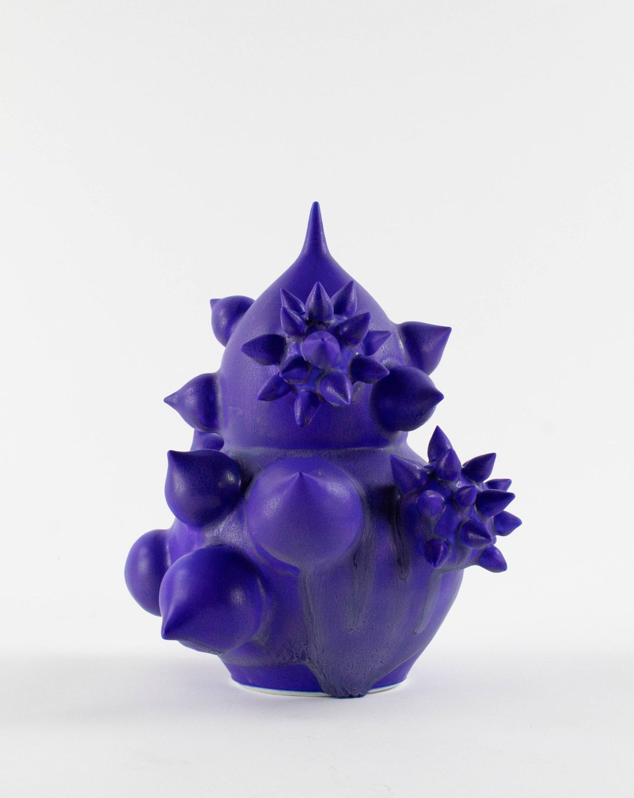 Violet matte porcelain form covered in spikes