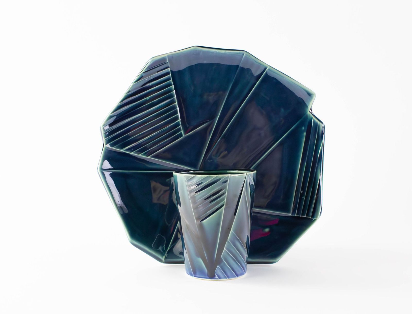Faceted blue-green porcelain platter with a matching cup