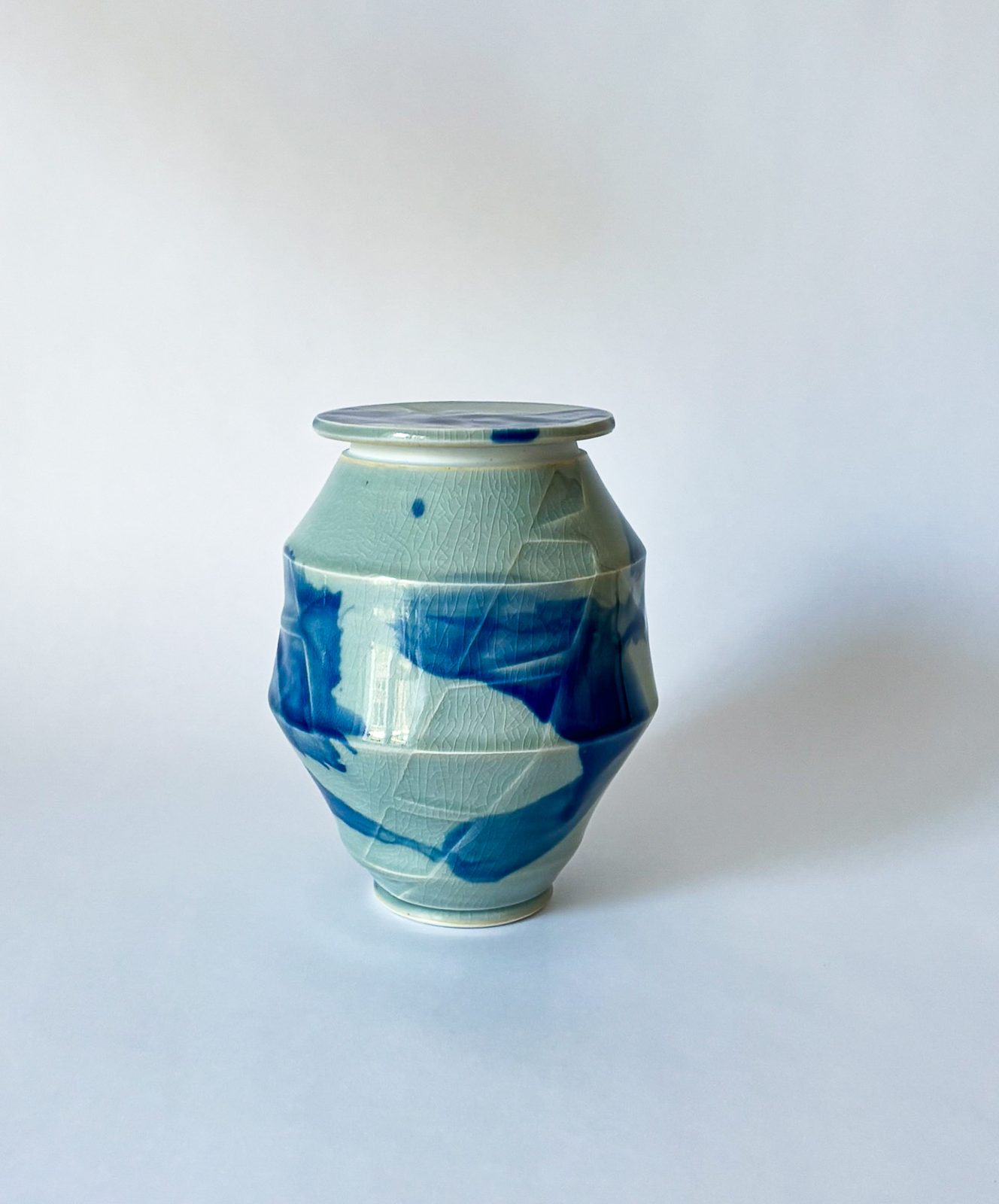 Faceted celadon lidded jar with cobalt brushwork